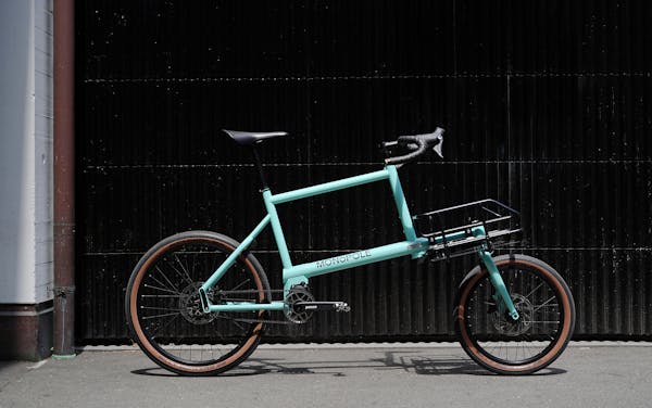 MONoPOLE No O1 drop bar blue cargo bike in front of a garage door