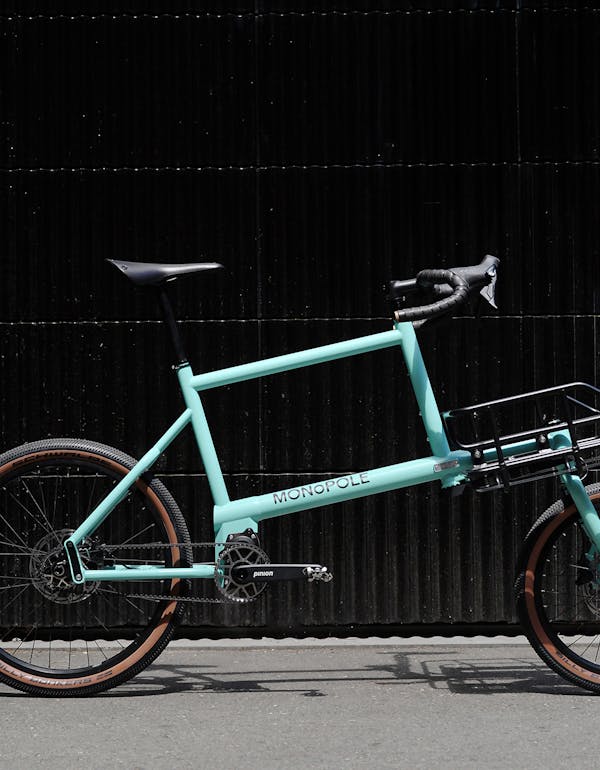 MONoPOLE No O1 drop bar blue cargo bike in front of a garage door