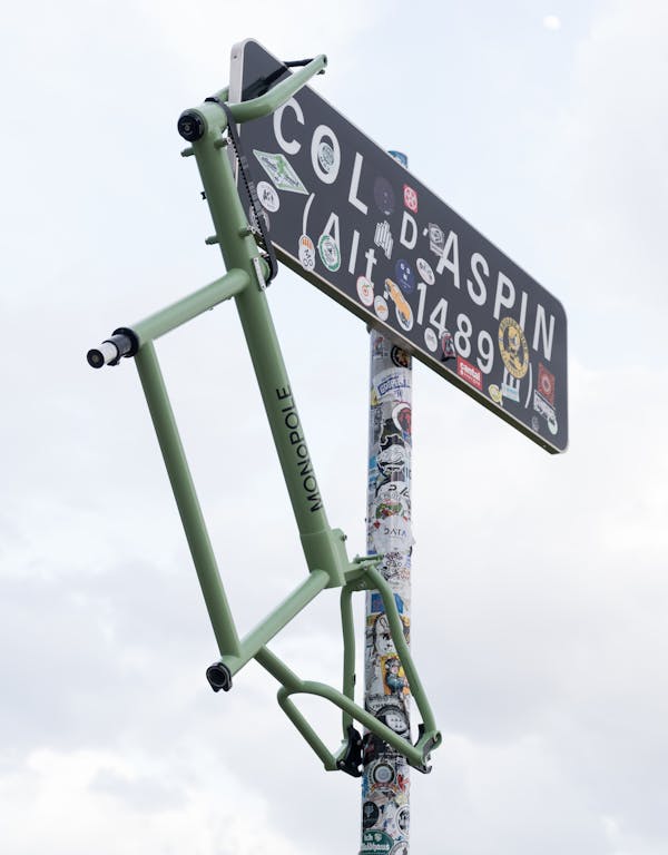 bike frame hanging from road sign