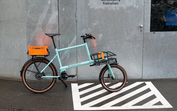 MONoPOLE blue cargo e-Bike, featuring the Shopper front rack, and Velokiste's rear rack.