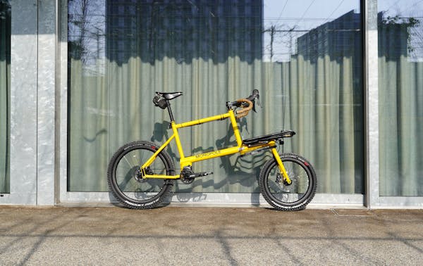 MONoPOLE custom yellow cargo e-bike with drop bar, featuring the Platform front rack.