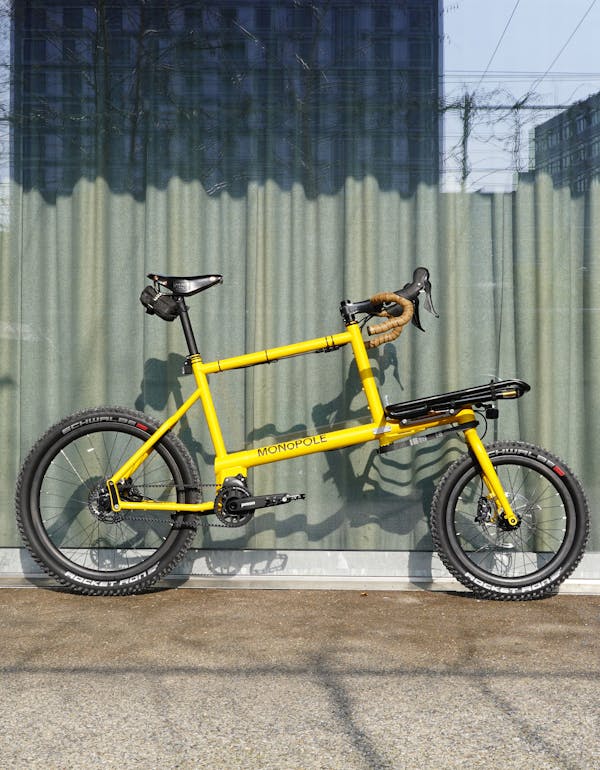 MONoPOLE custom yellow cargo e-bike with drop bar, featuring the Platform front rack.
