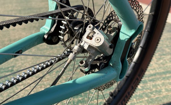 Close-up of a blue MONoPOLE rear triangle featuring a mechanical disc brake by Growtac.
