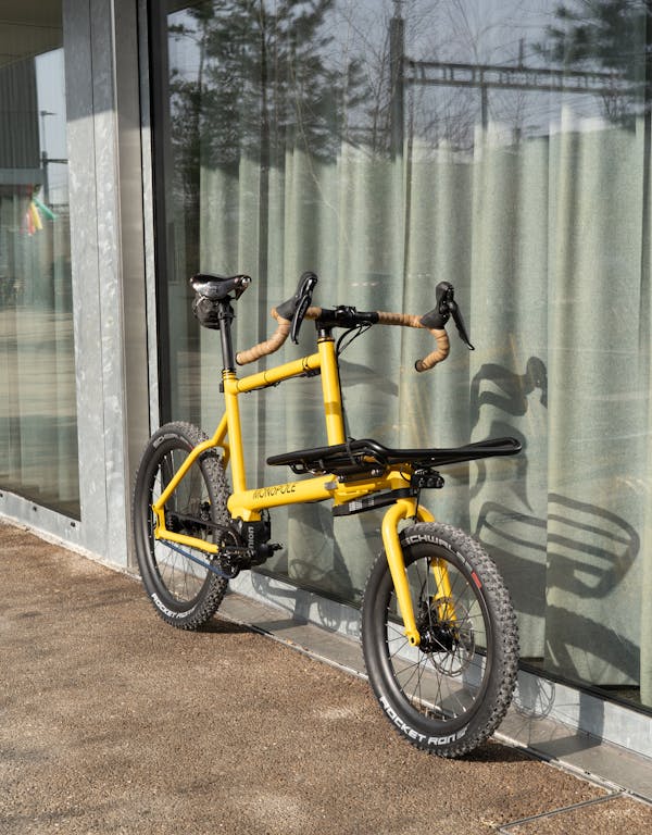 MONoPOLE custom yellow cargo e-bike with drop bar, featuring the Platform front rack.