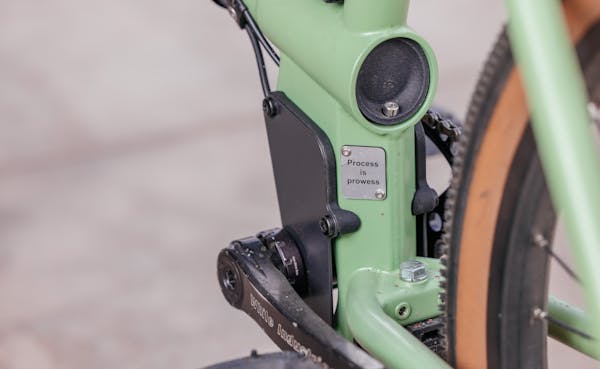Close-up of MONoPOLE cargo bike custom 'Process is Prowess' custom plate.