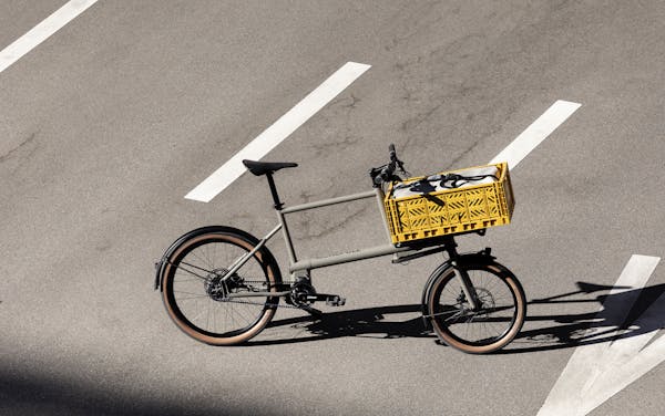 Cargo bike with yellow crate on the street