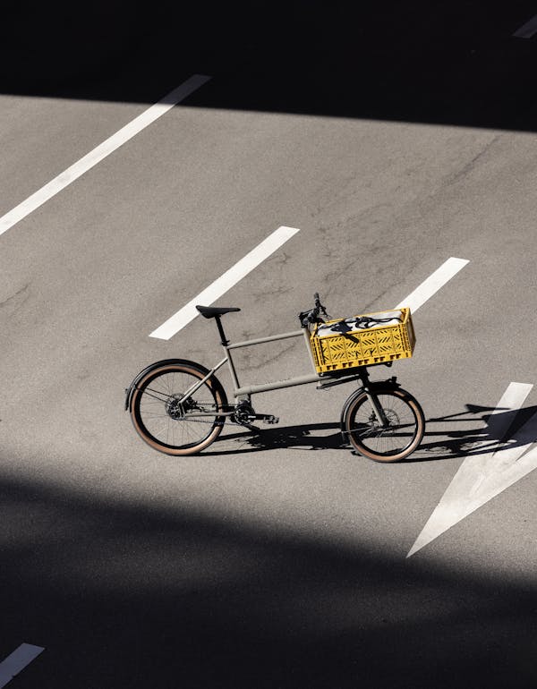Cargo bike with yellow crate on the street