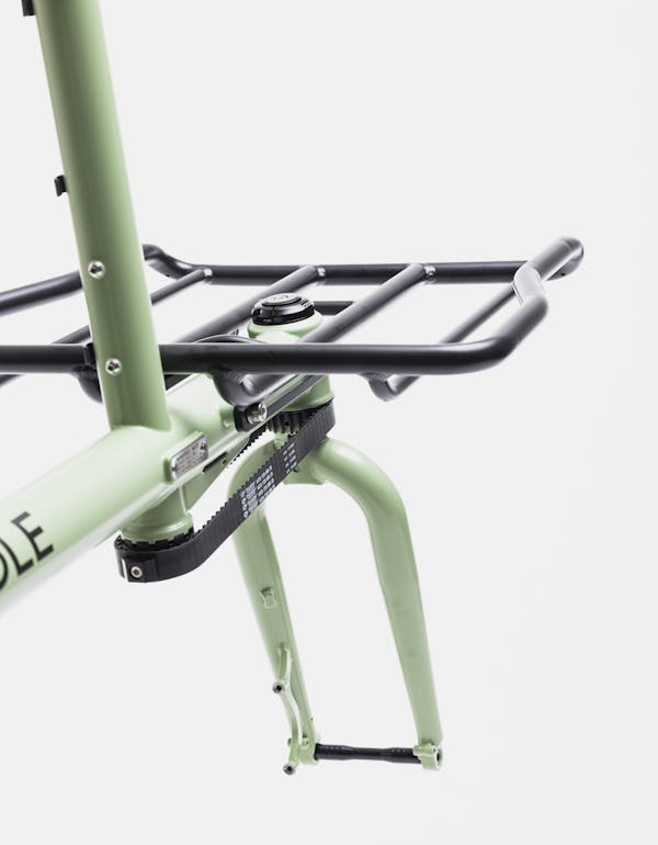 Detail shot from behind of a MONoPOLE cargo bike with cargo rack and proprietary belt steering