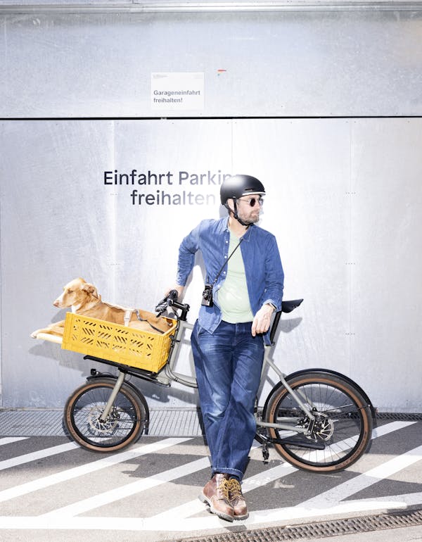 Man carrying dog on a cargo bike