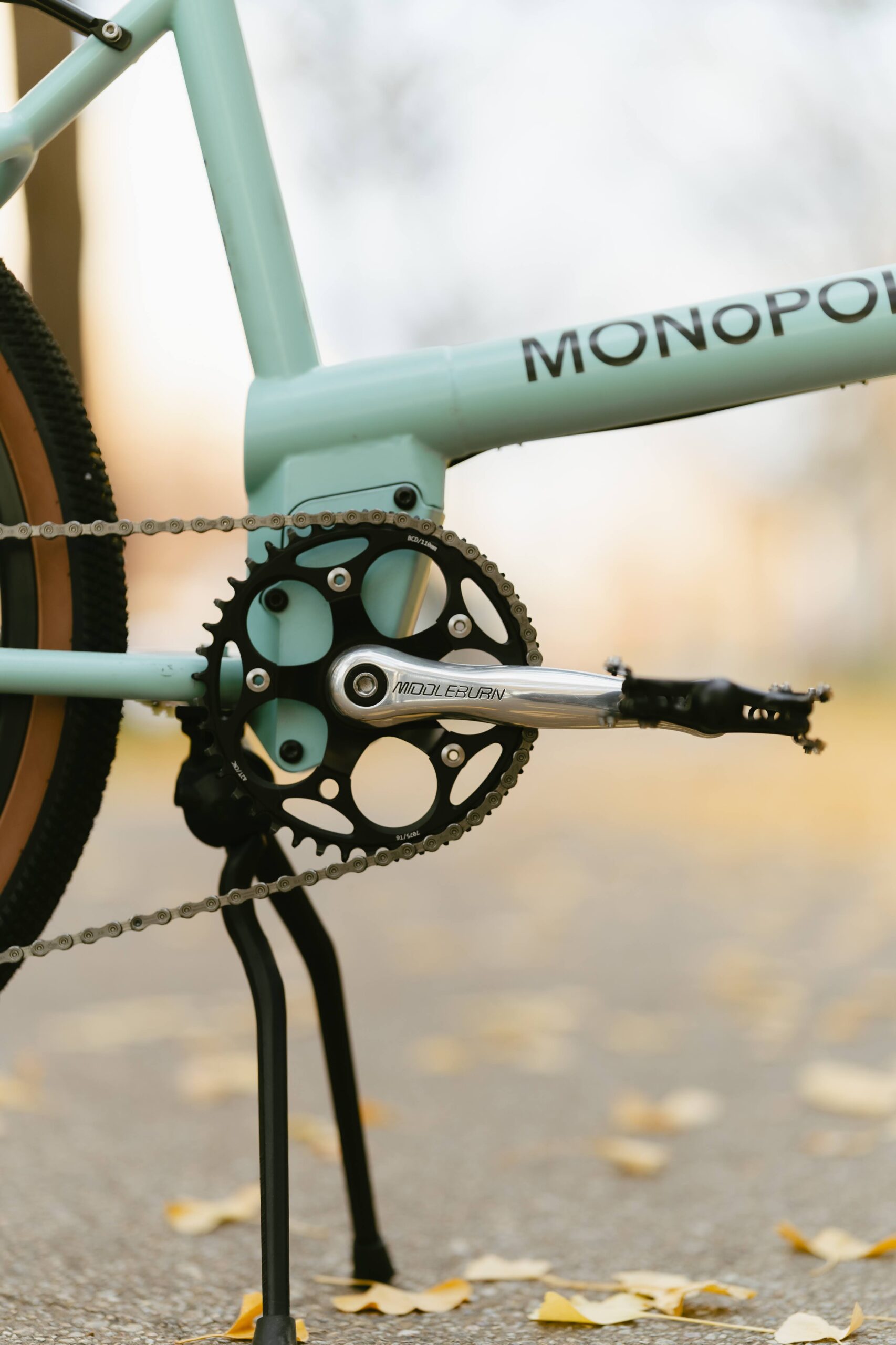 Close-up of a Freshwater blue cargo bike showing the crank, pedal, and kickstand.