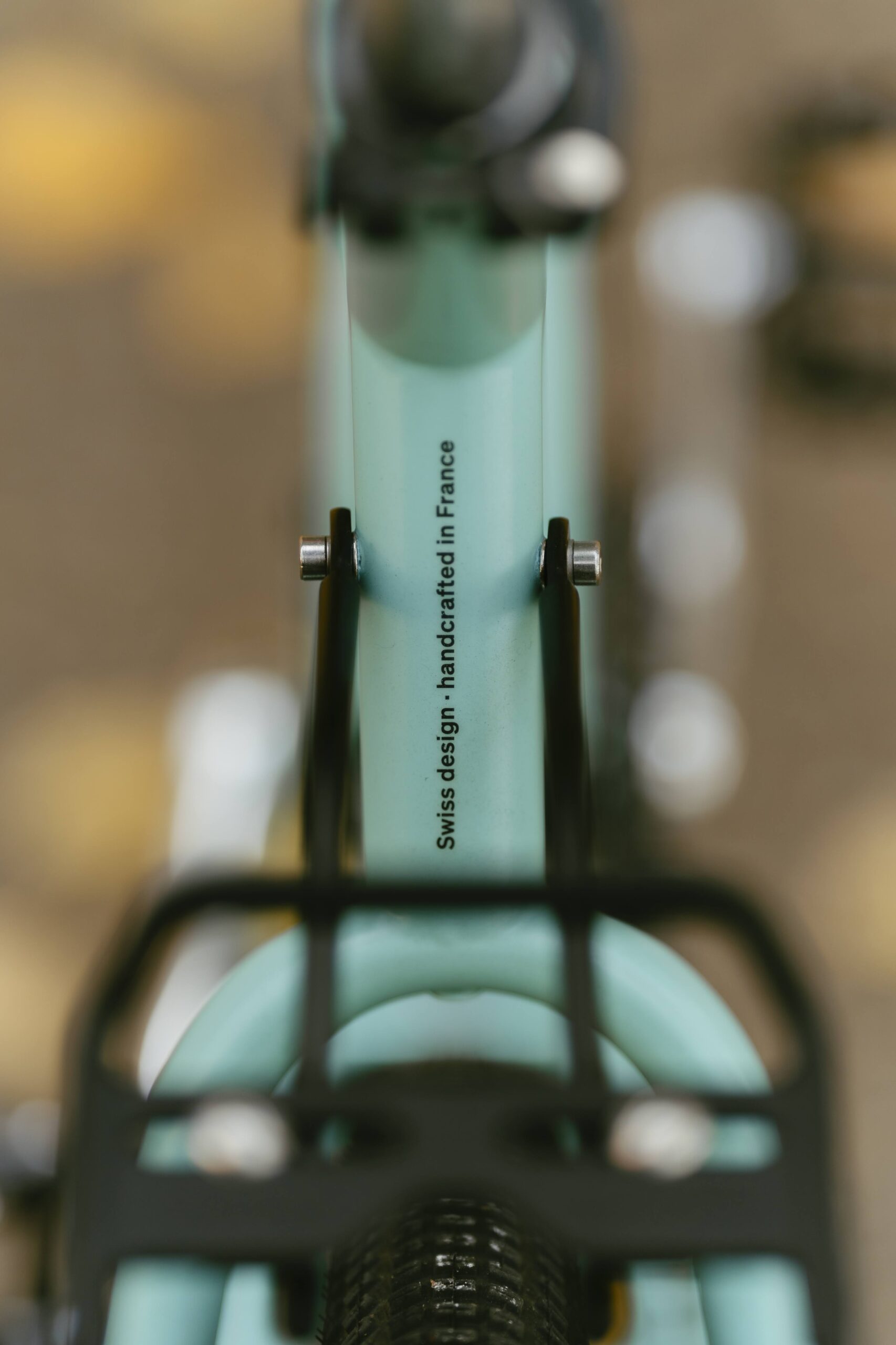 Backside detail of a custom MONoPOLE cargo bike pole with the slogan “Swiss design—handcrafted in France"”