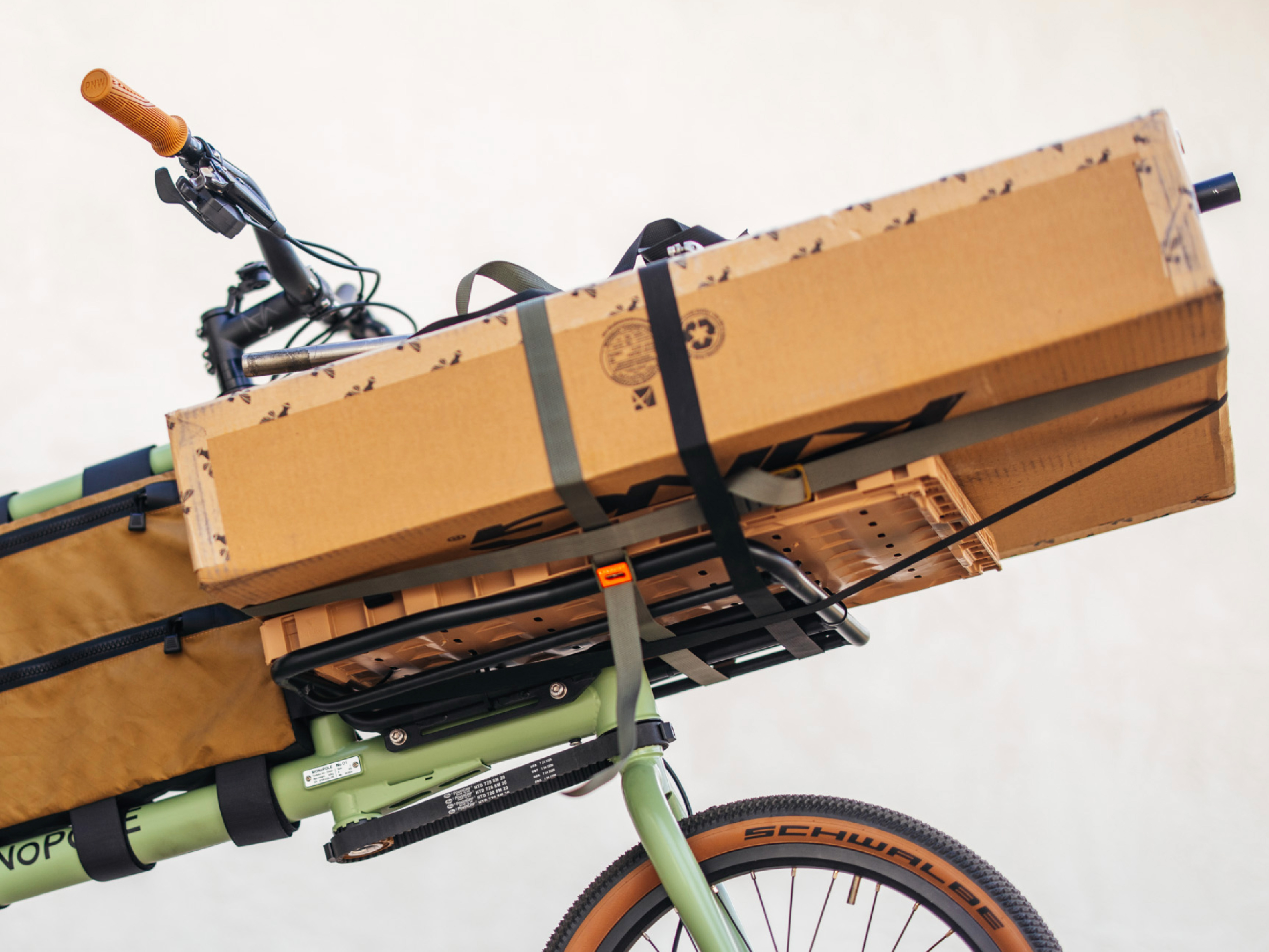A MONOPOLE No O1 cargo bike transporting a large package on its front rack.