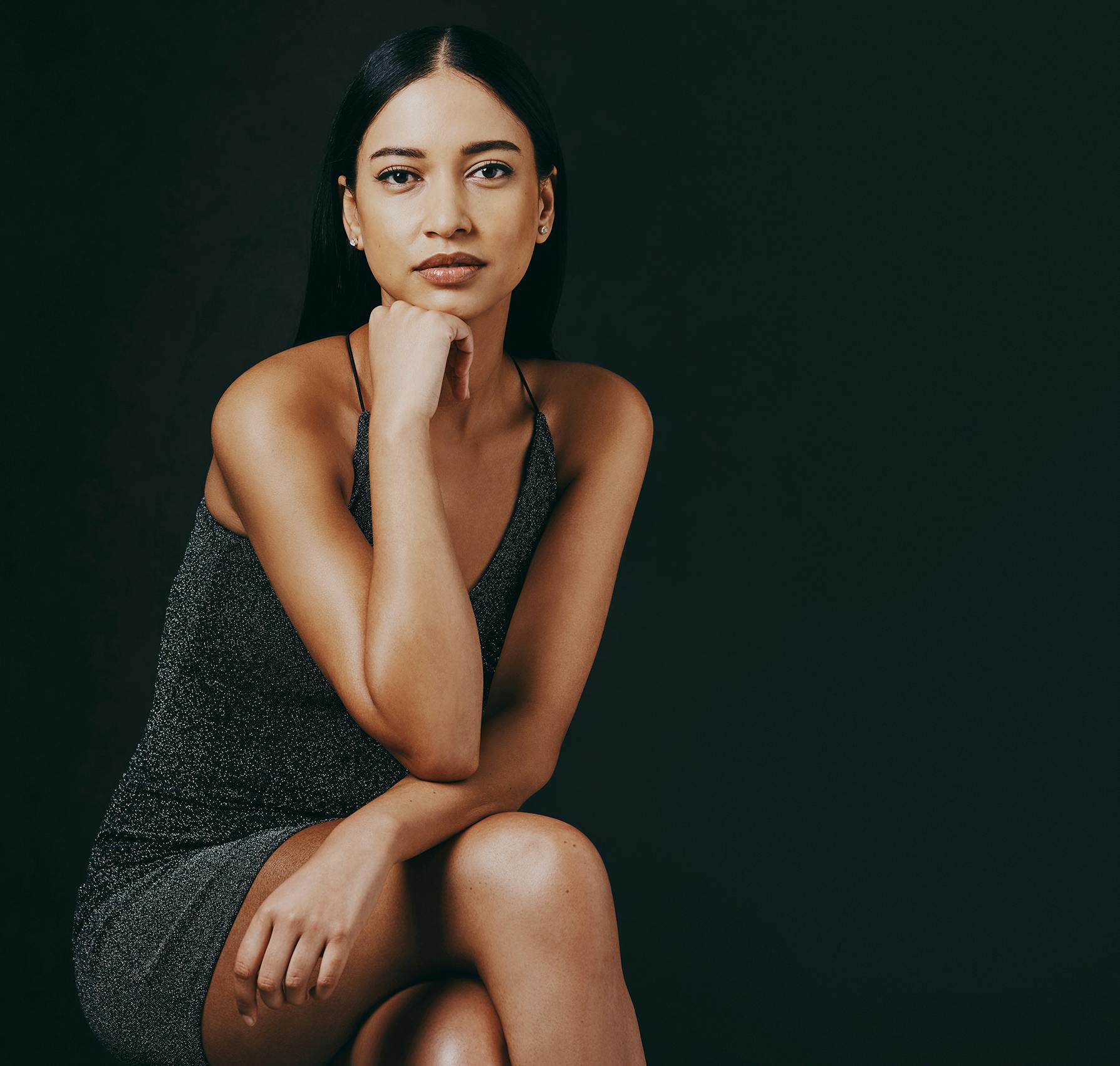 Woman sitting down holding her chin