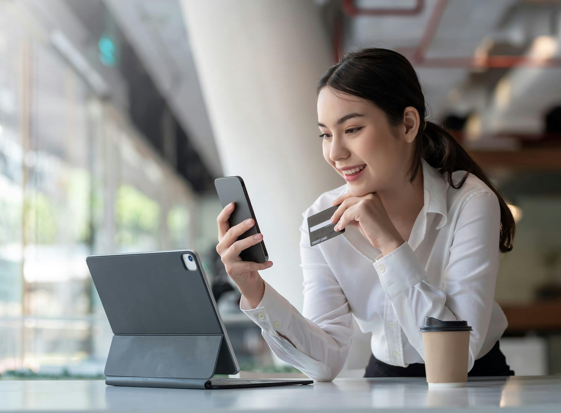 Woman with phone and computer