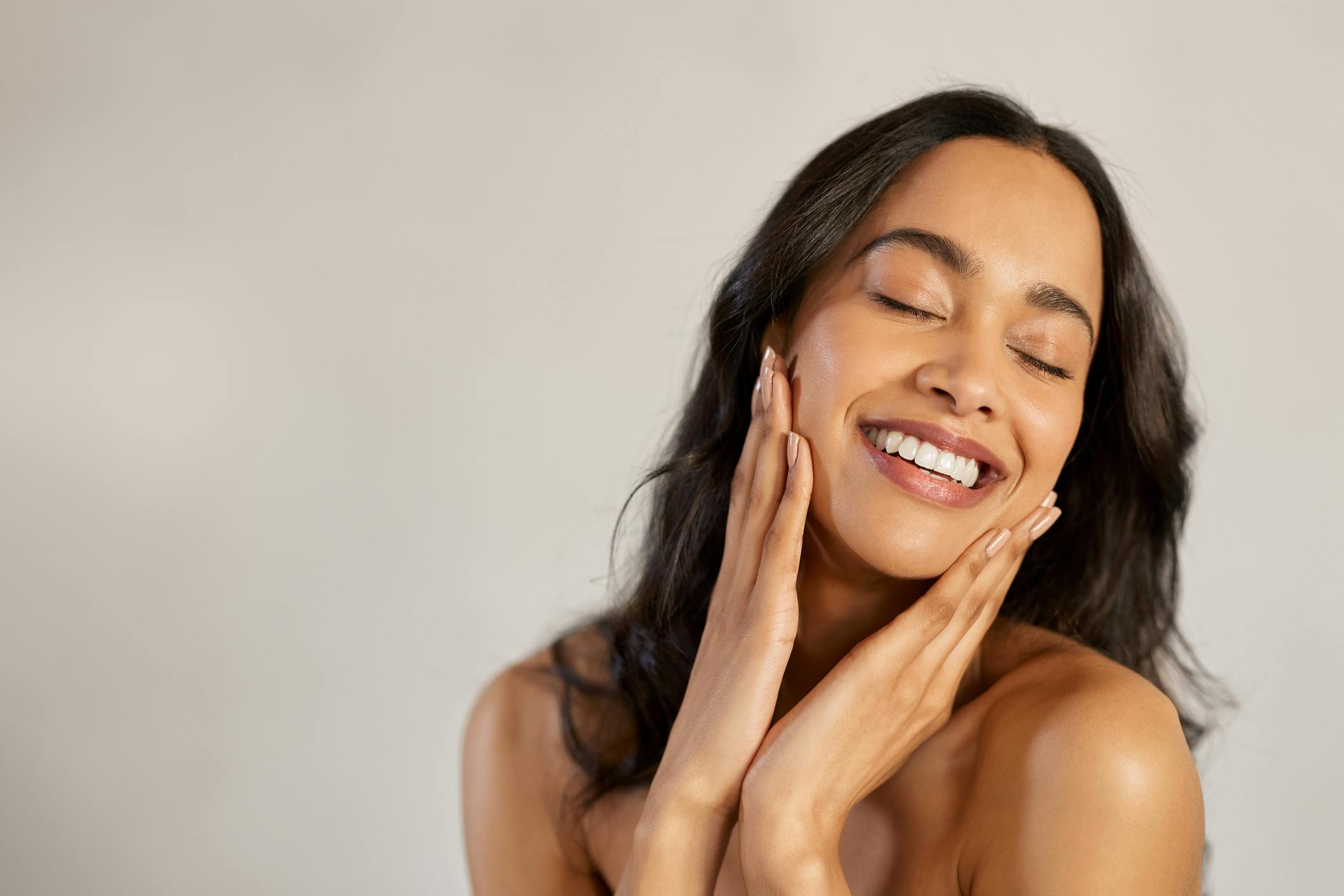 Woman touching her face smiling
