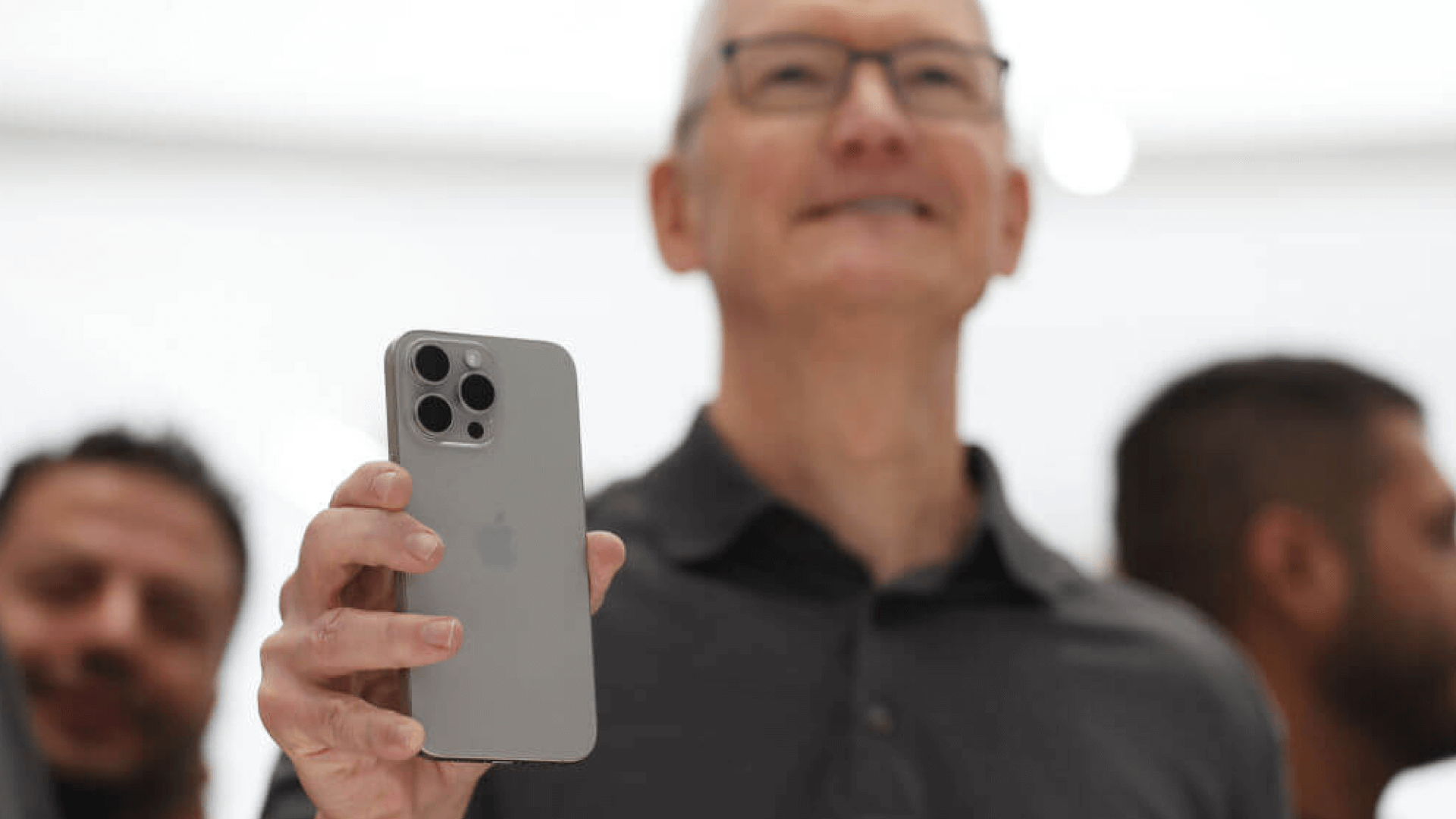 Tim Cook holding the iPhone 15