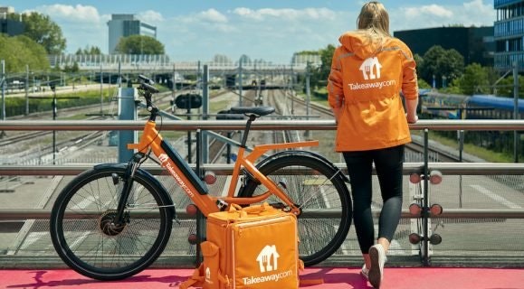 Woman standing alongside a bike