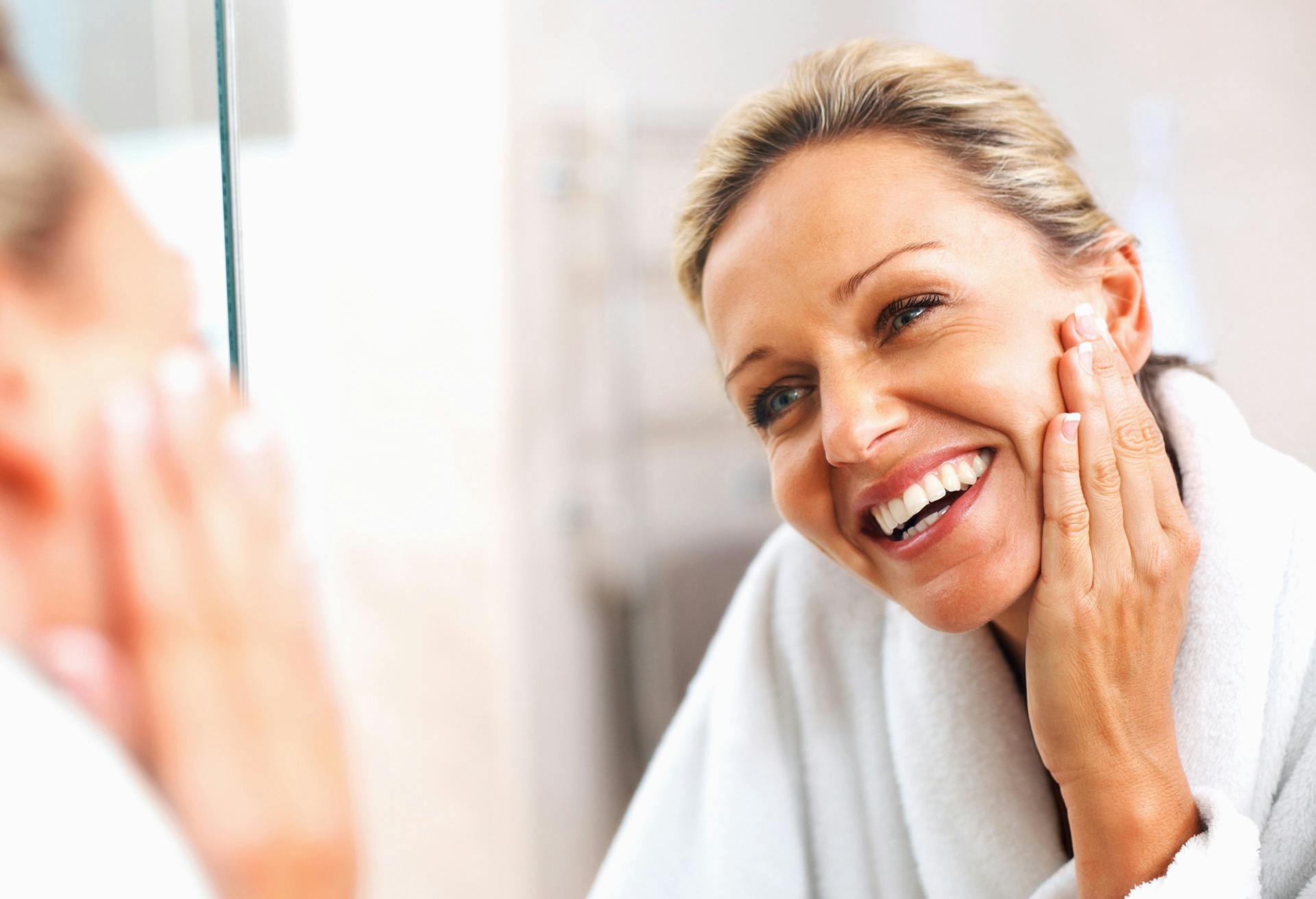 Woman Smiling at Her Reflection