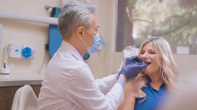 Dr. Chow Working on a Patient