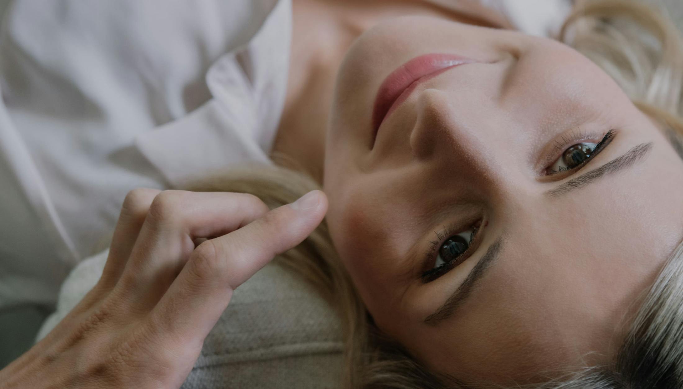 Woman lying on her back smiling.