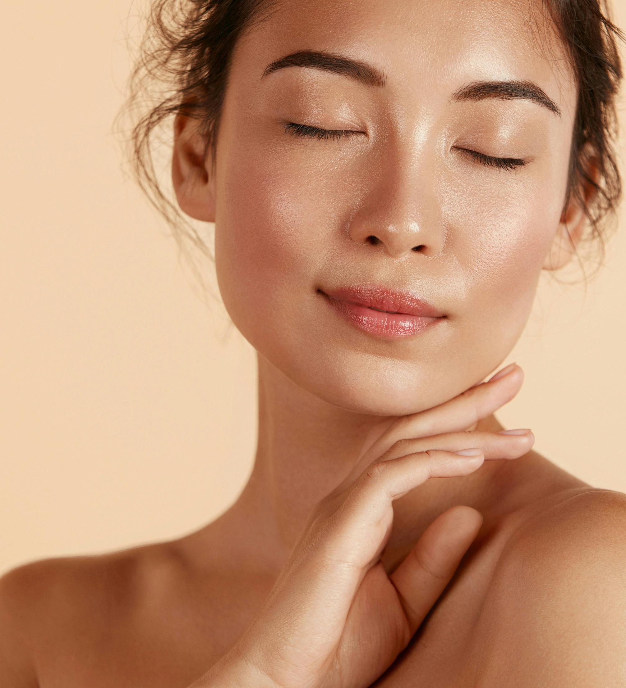 Woman smiling with her hand on her cheek
