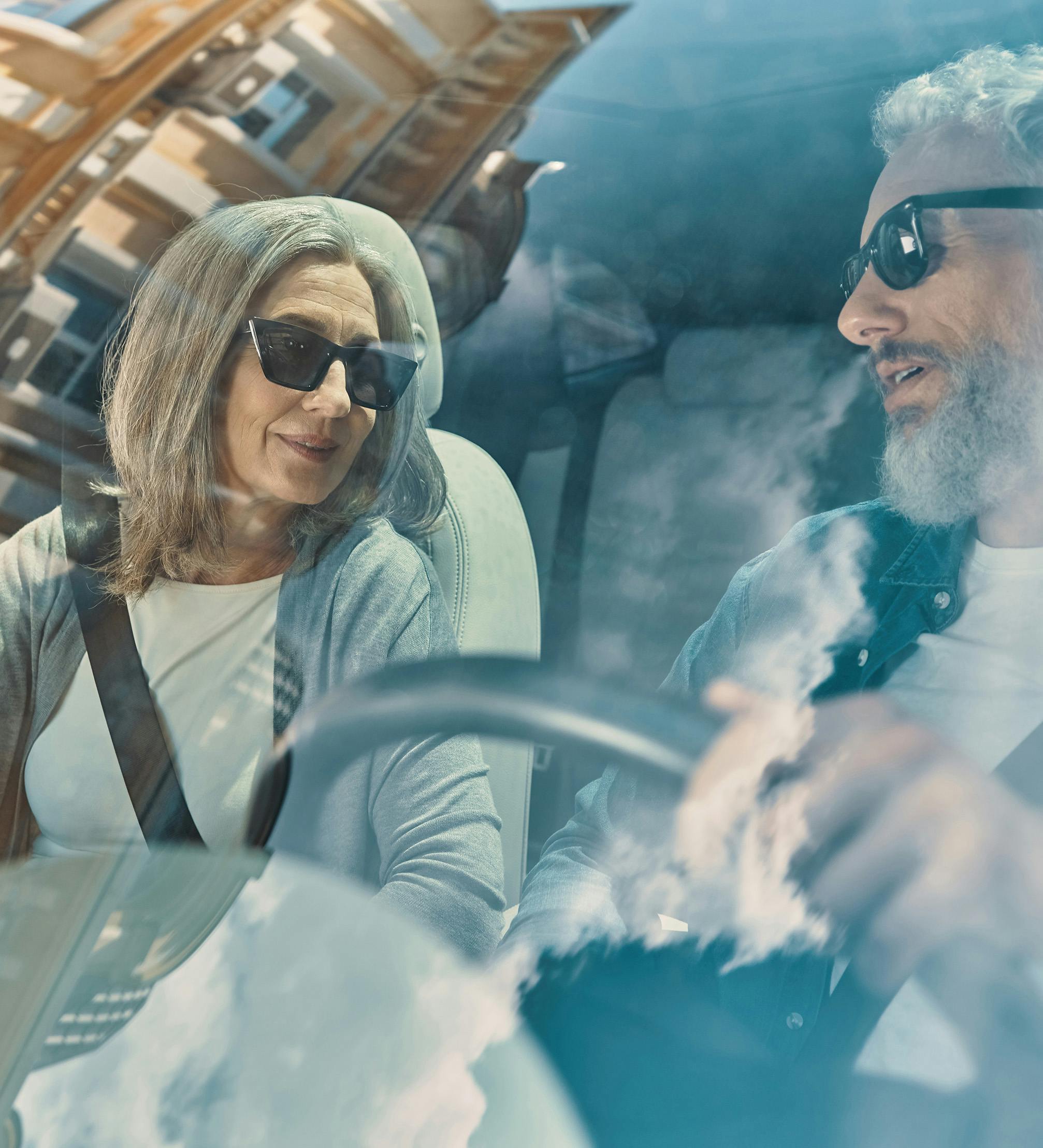 Two people driving in a car.