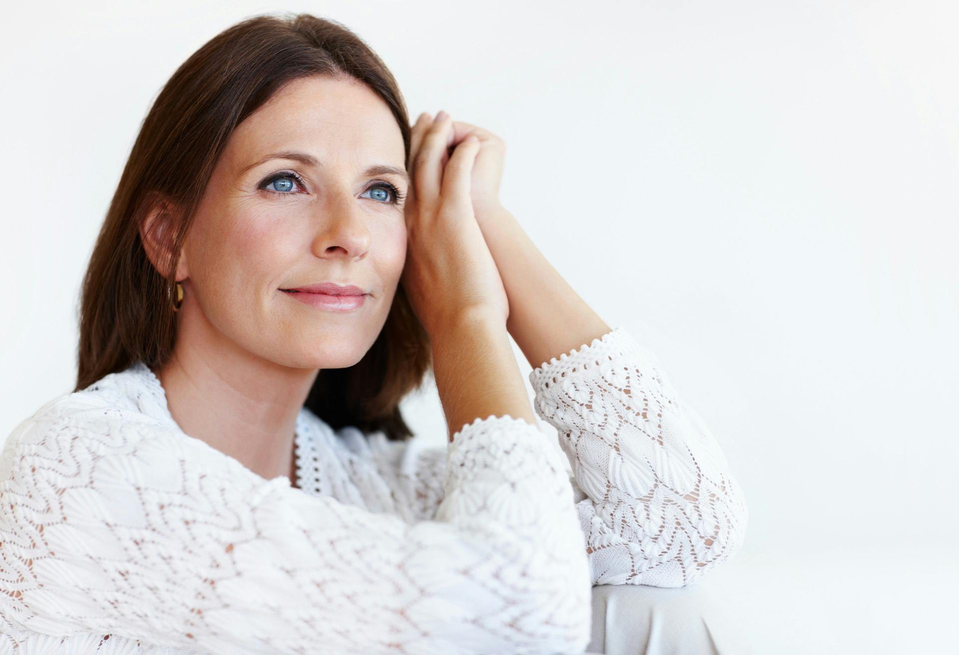 brown haired woman smiling and looking off camera