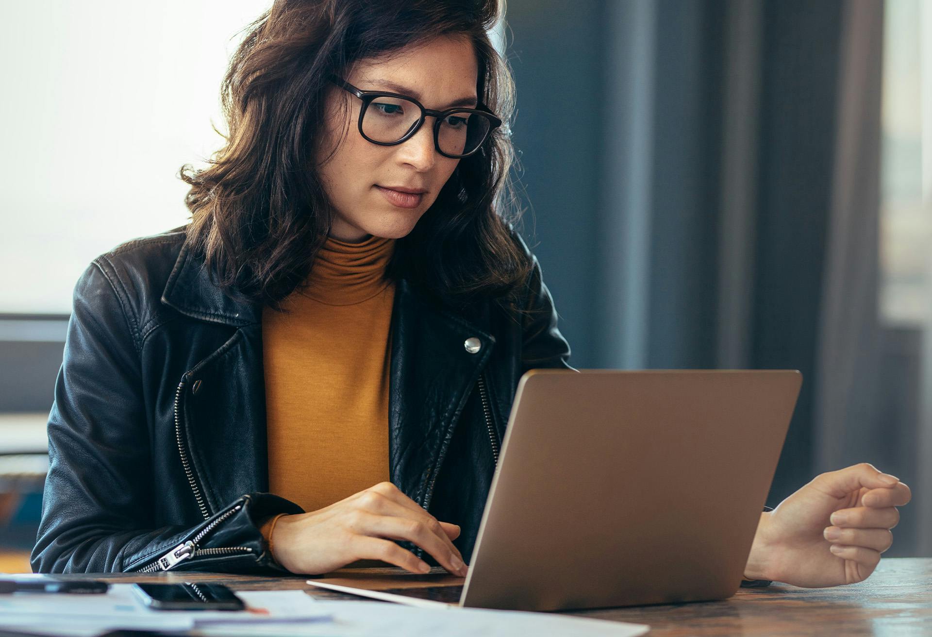 Woman working on a laptop.