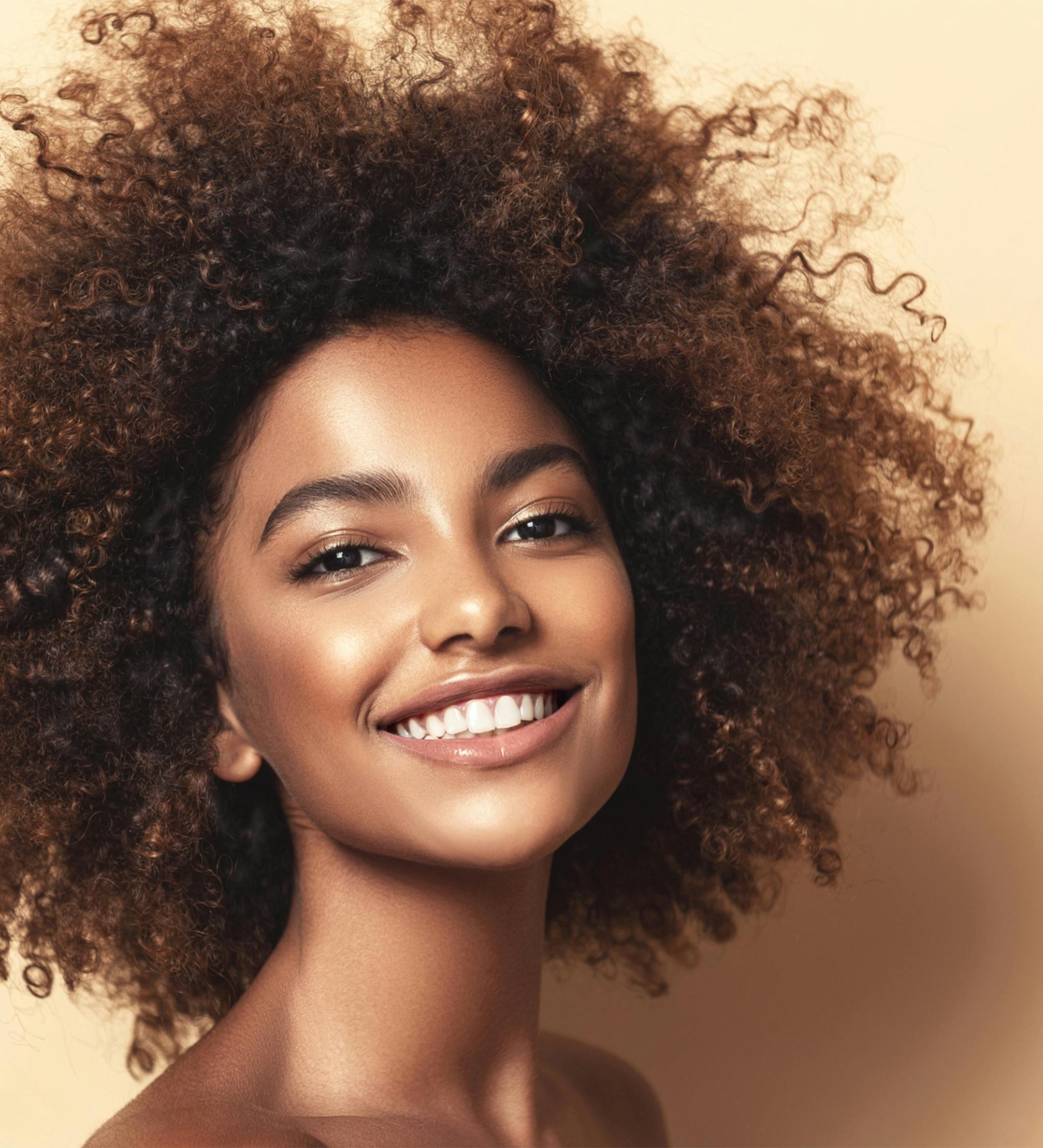 Smiling woman with wild hair.