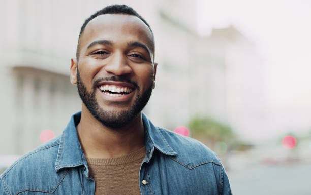 Man smiling with city in the background