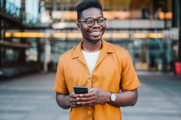 Man smiling and holding phone