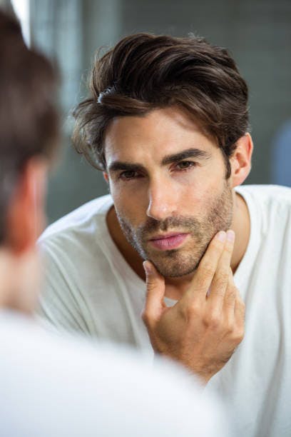 Man looking at himself in the mirror
