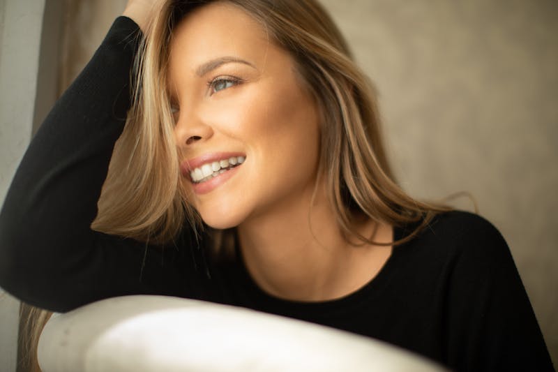 A woman in a black shirt smiling