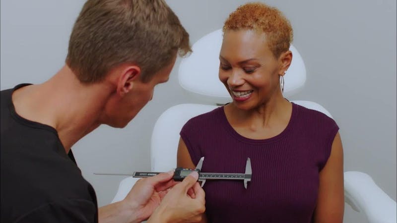 Woman getting her breast measured for procedure