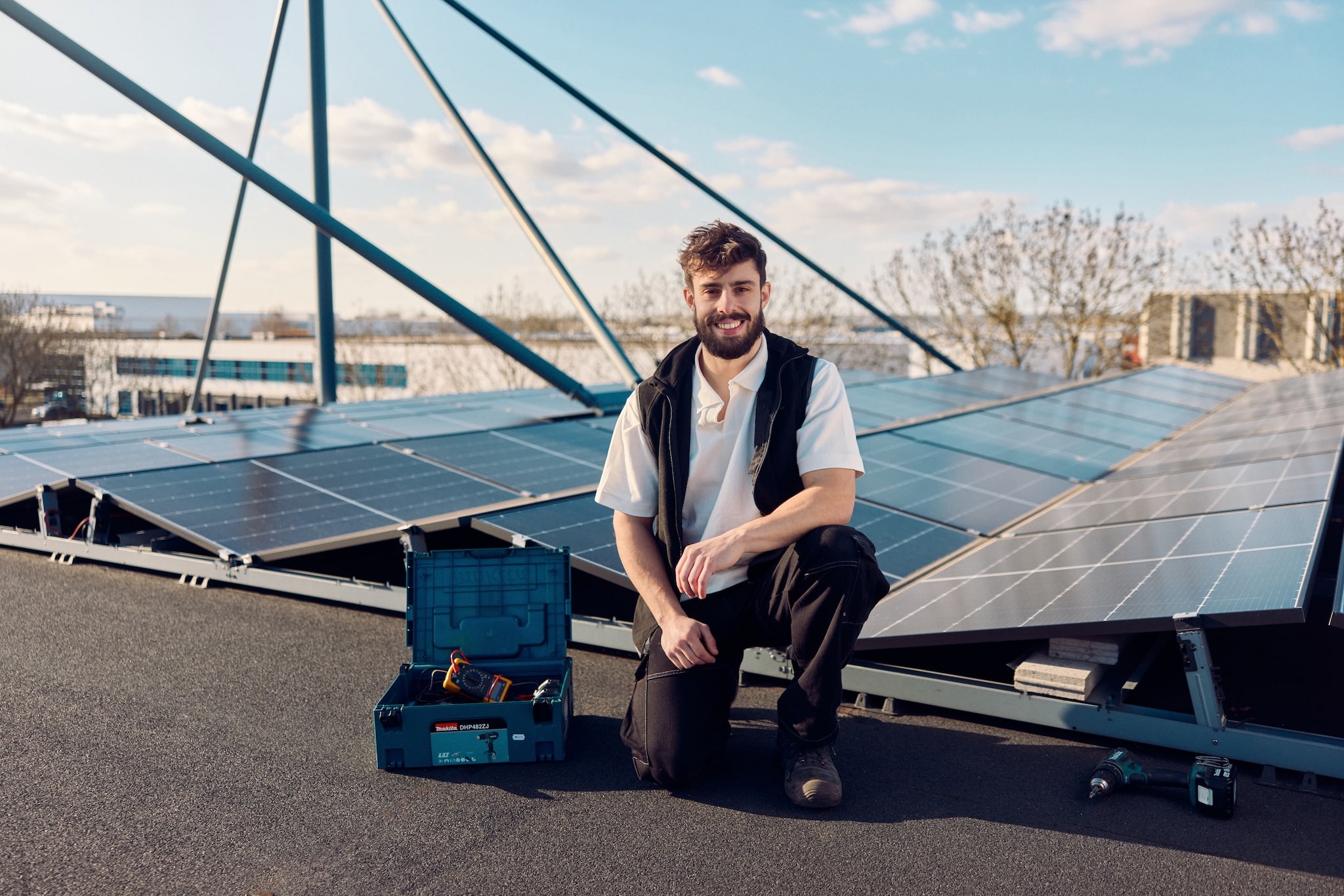 A electrician standing on the roof with solar panels
