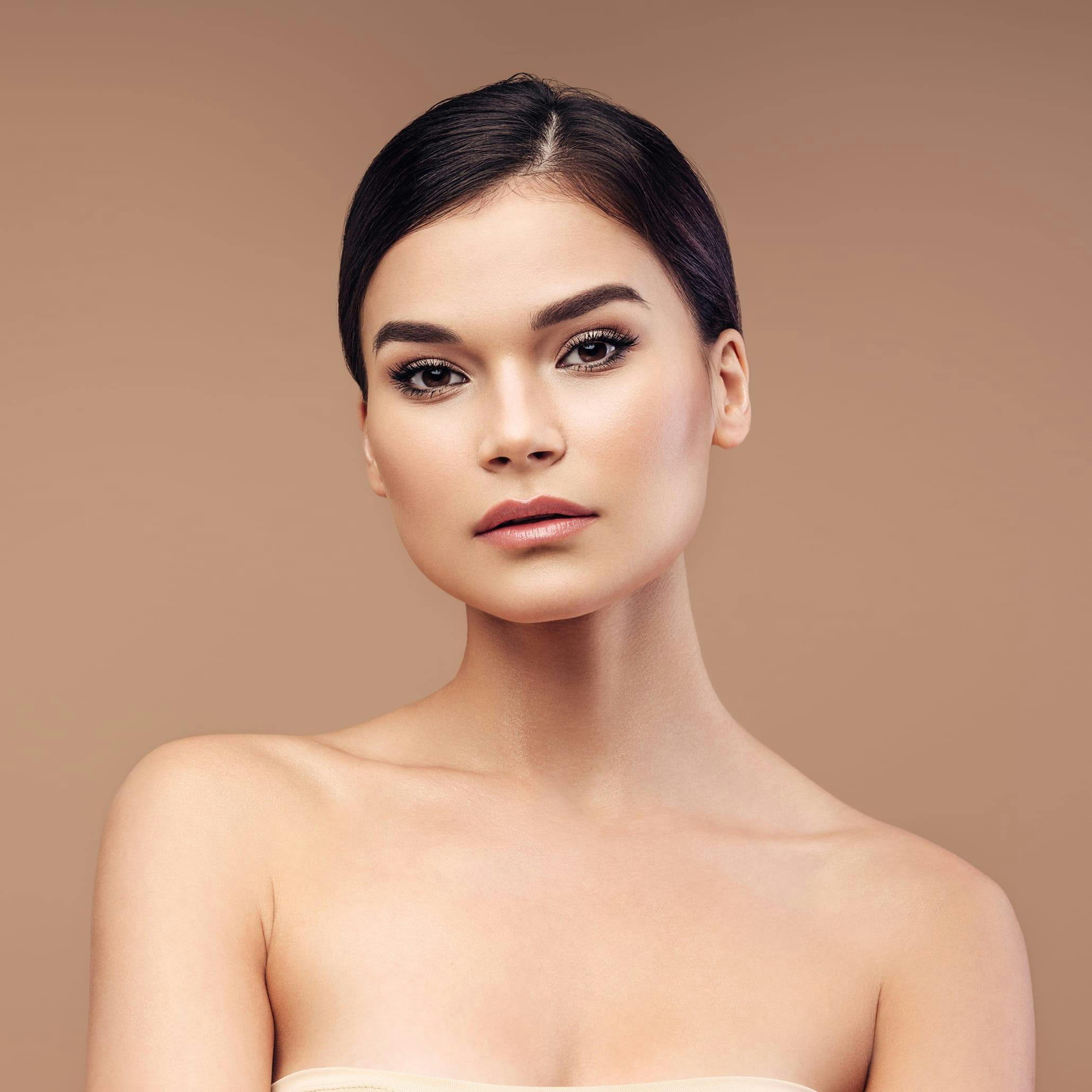 Woman with dark hair slicked back