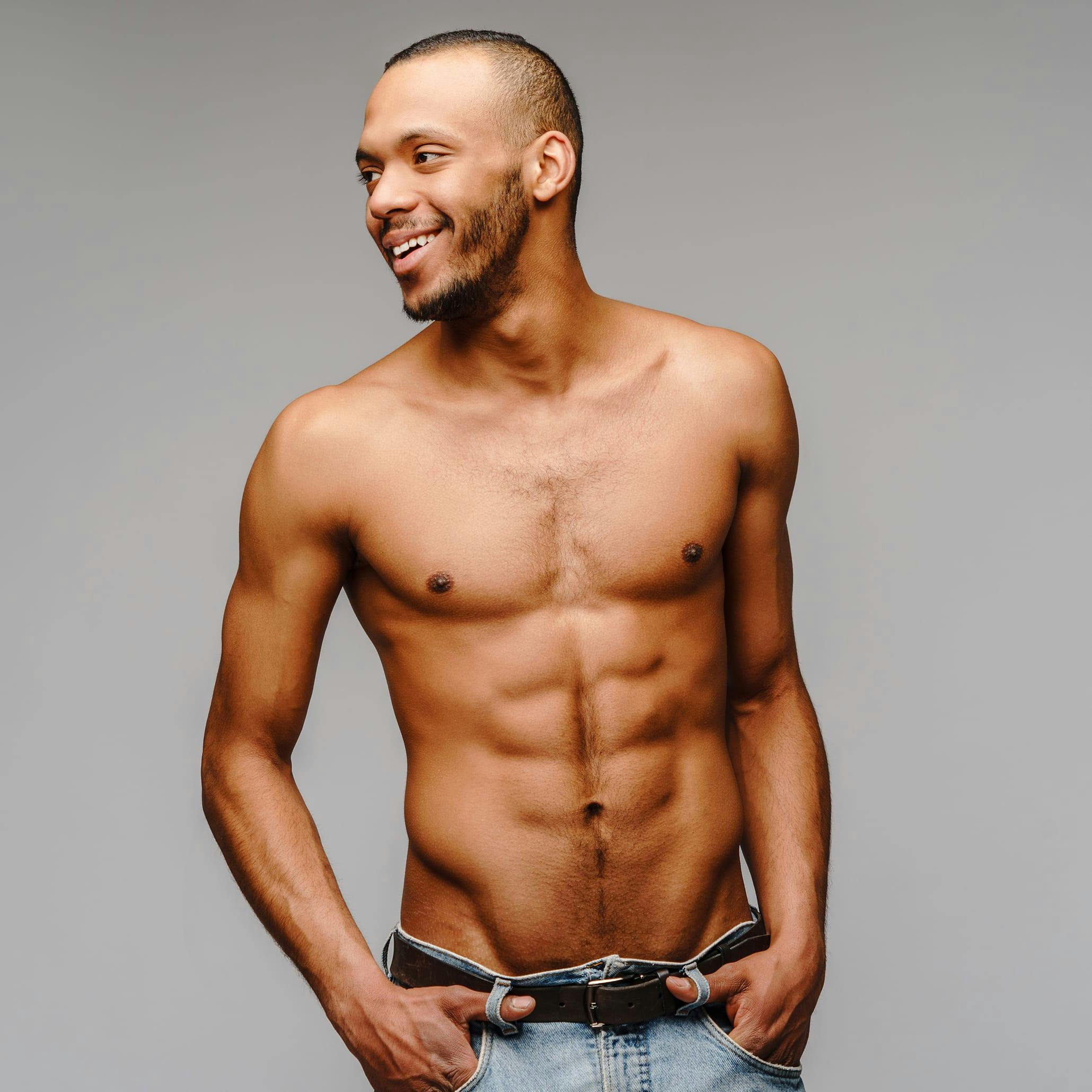 Handsome man with his shirt off with sculpted abs