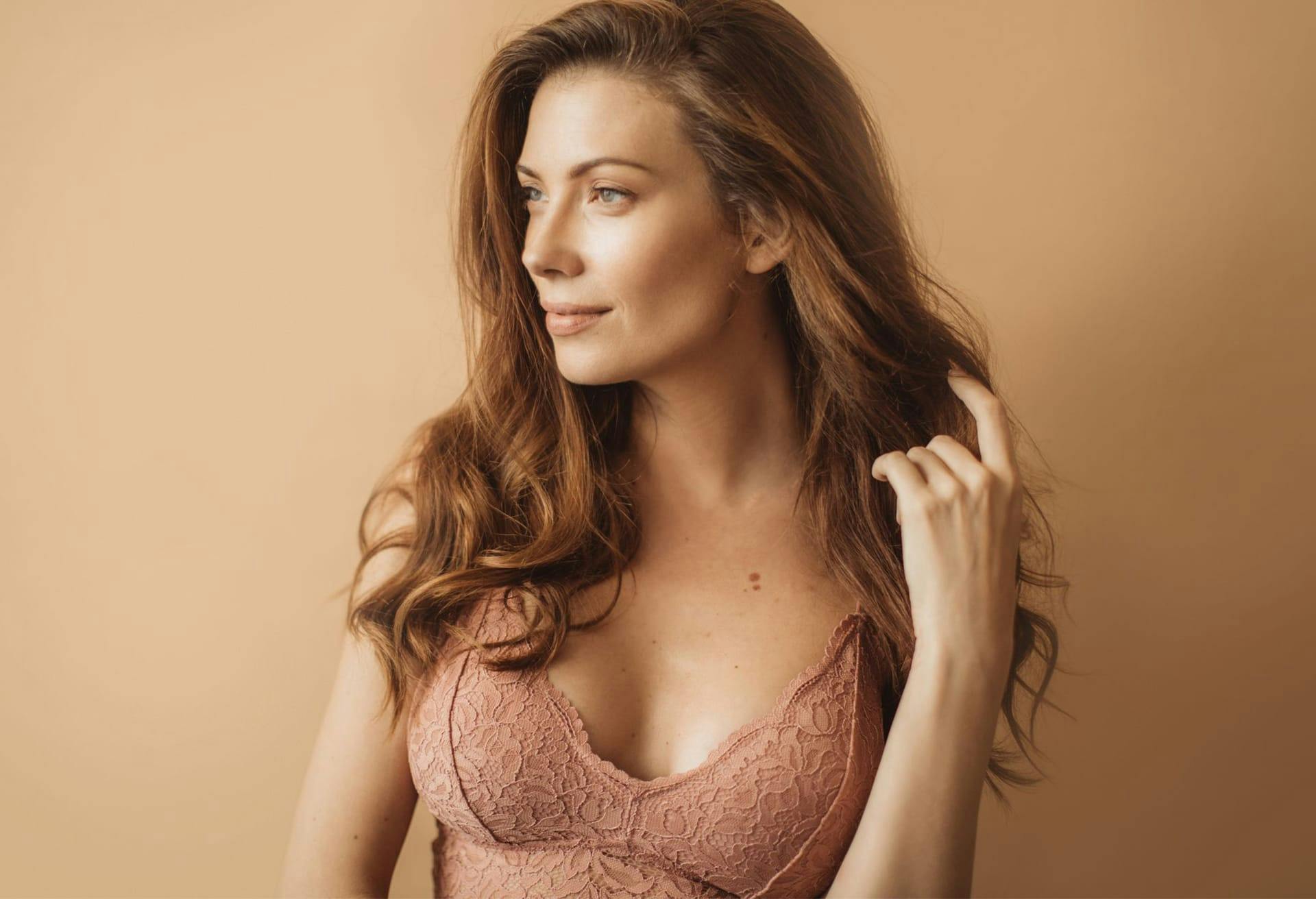 Woman in a lacy salmon colored bra