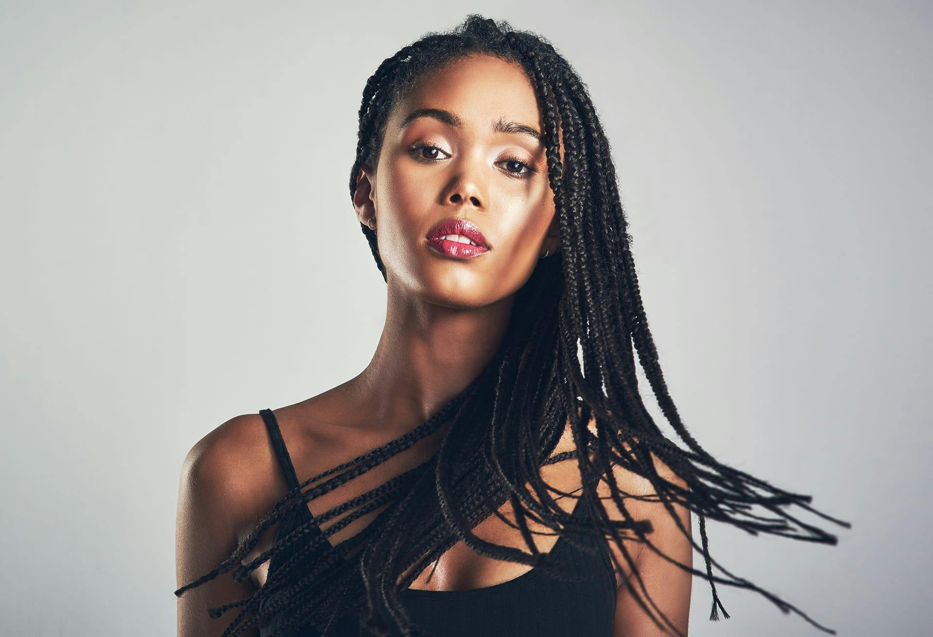 Beautiful woman with glowing skin and long black braids