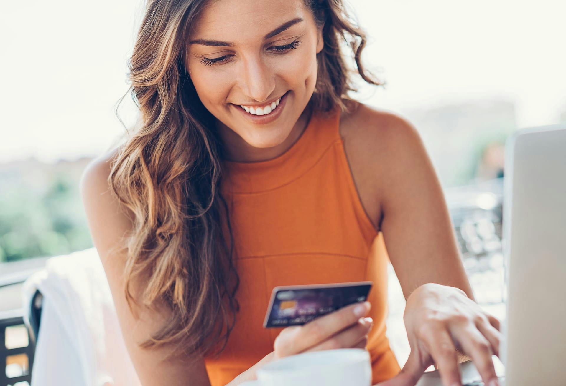 woman looking at credit card