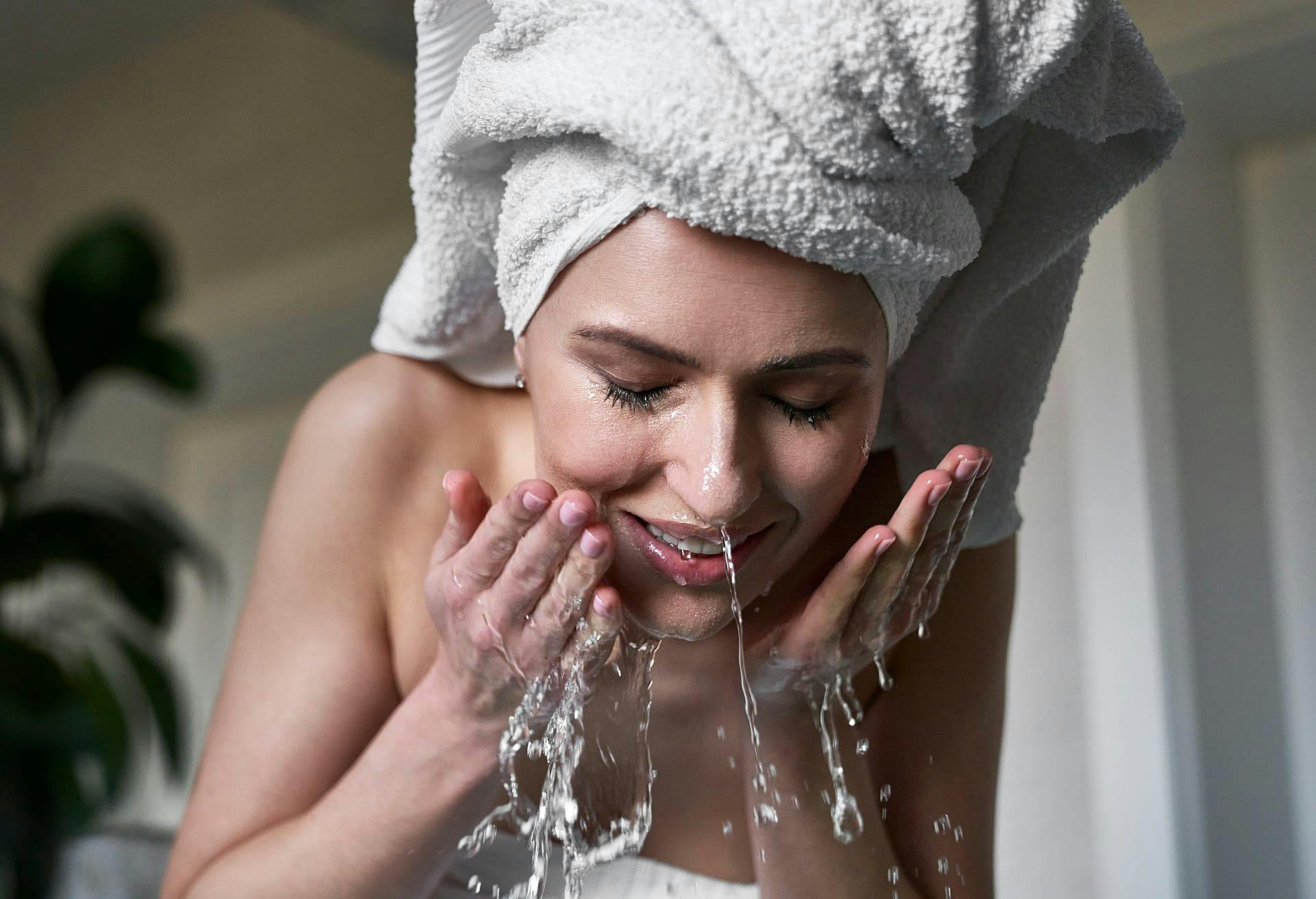 woman rinsing face
