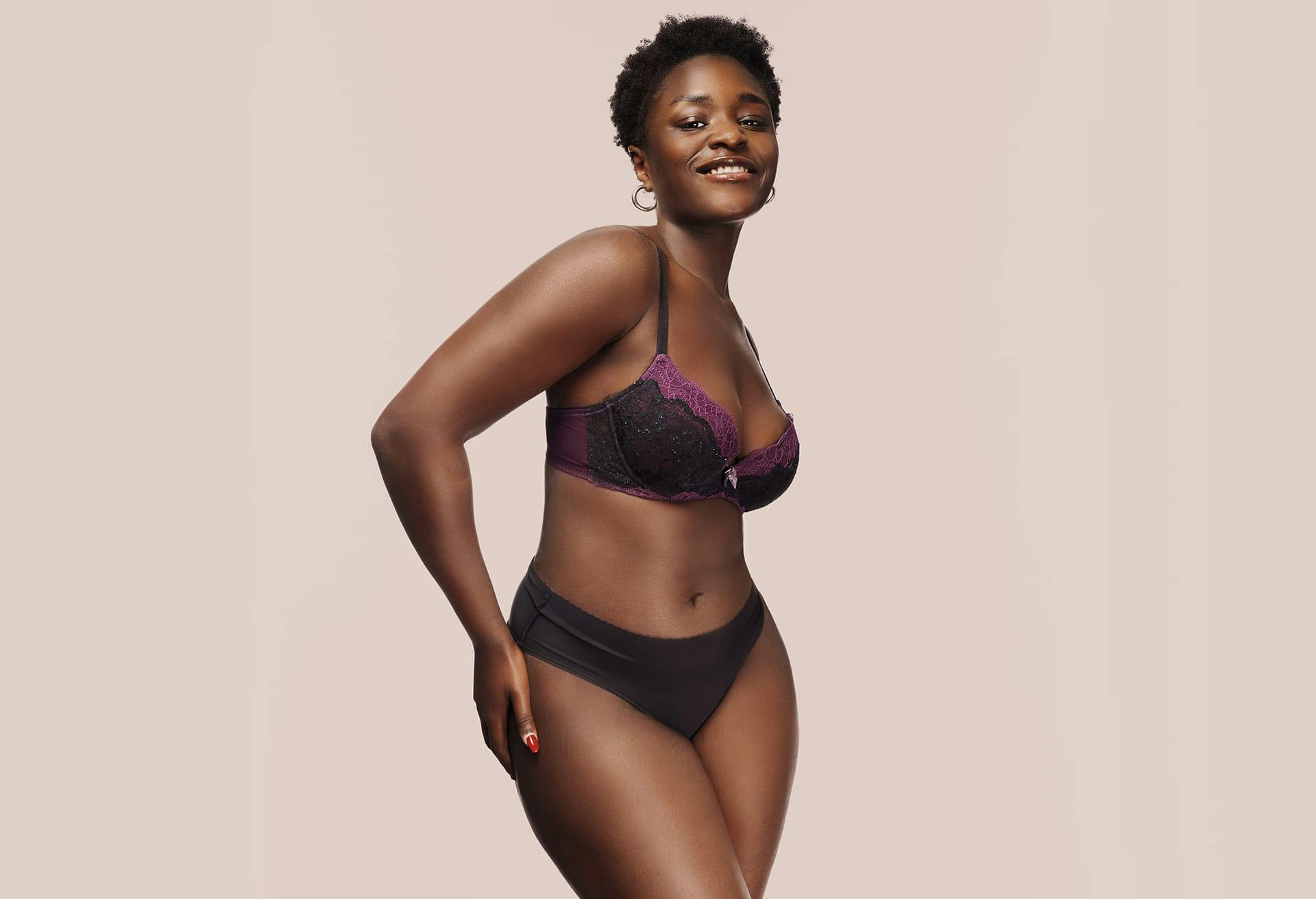 Woman in a black and purple undergarments set