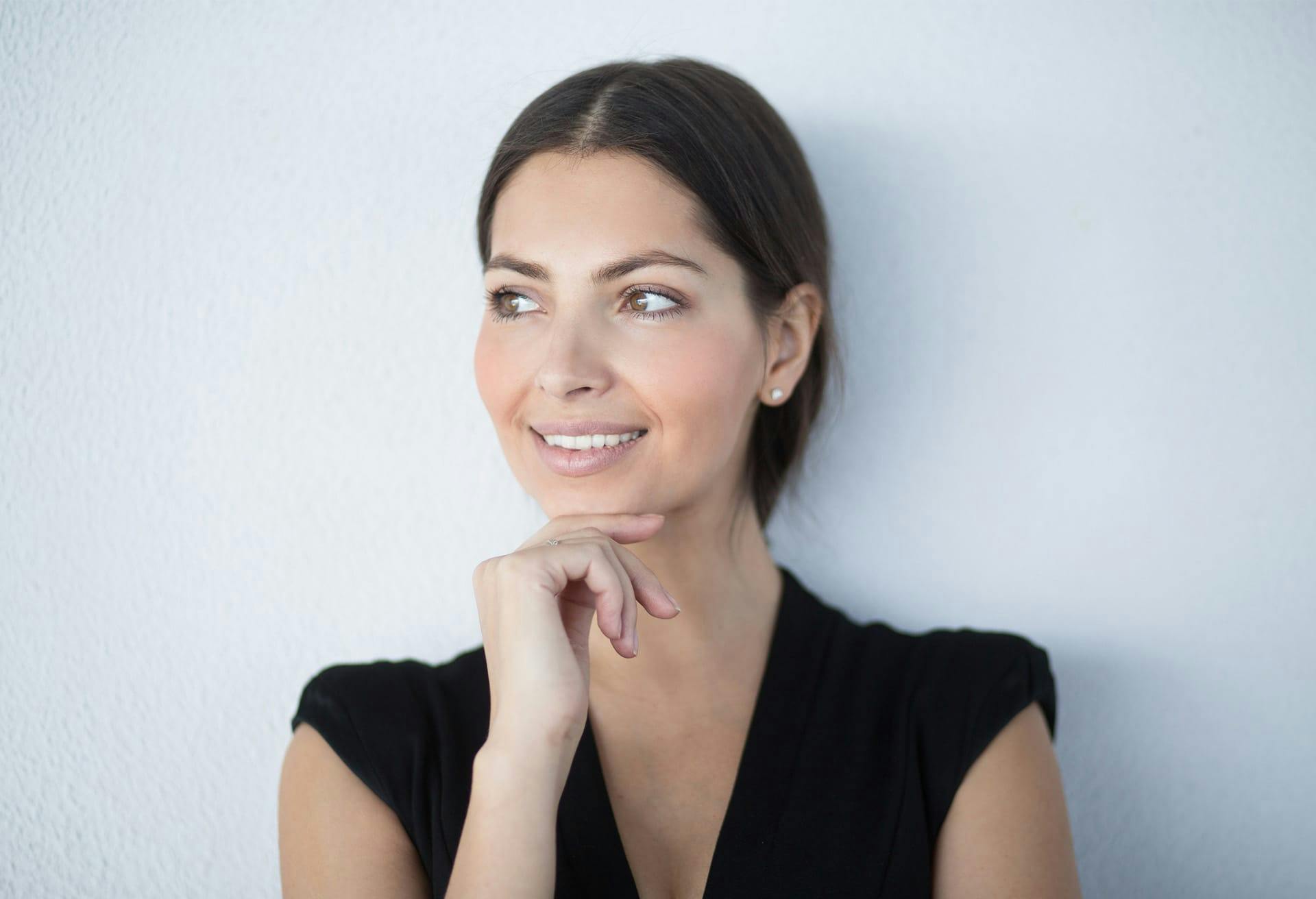 woman with hand on chin