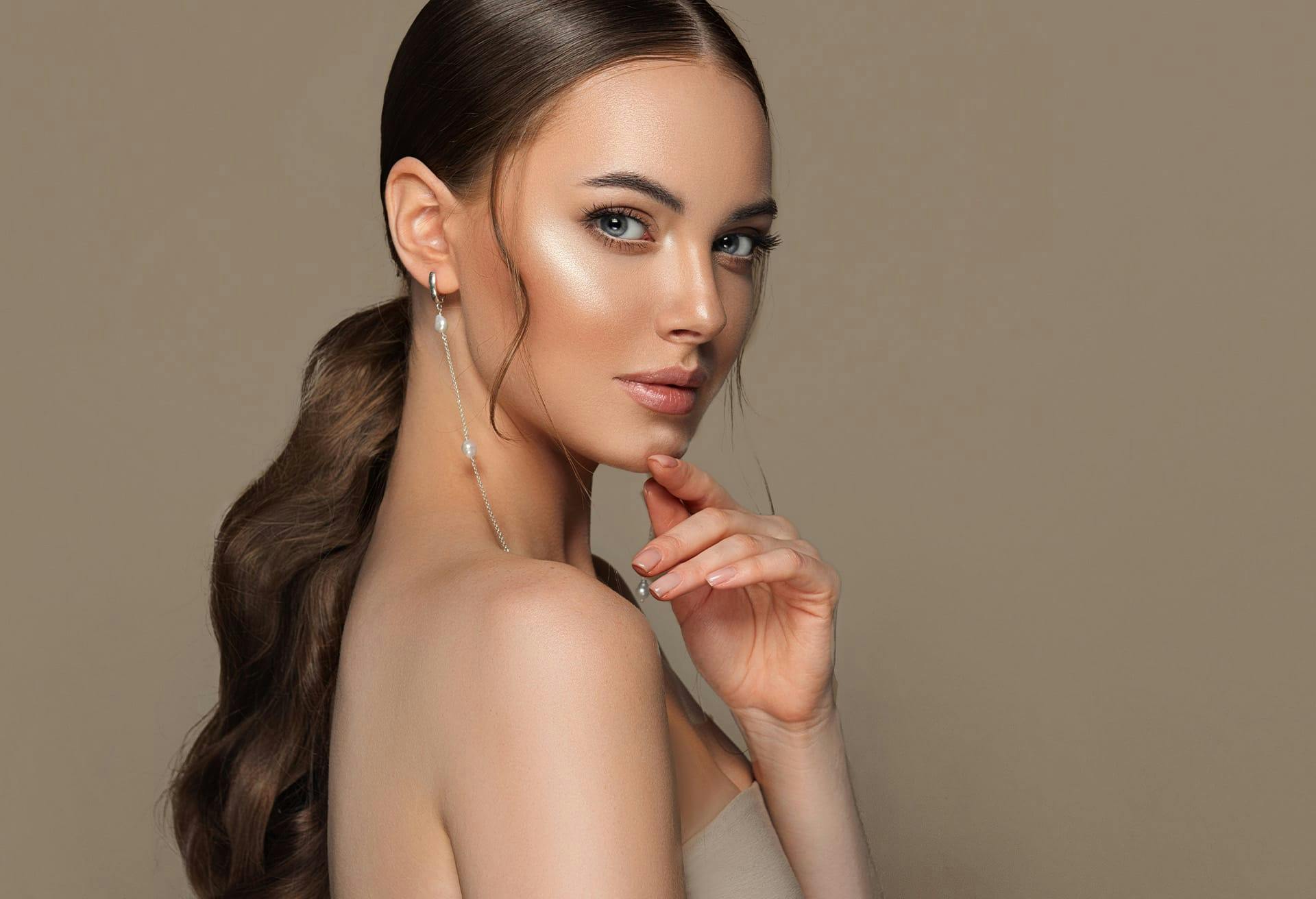 Glamorous woman with her hair pulled back and glowing skin