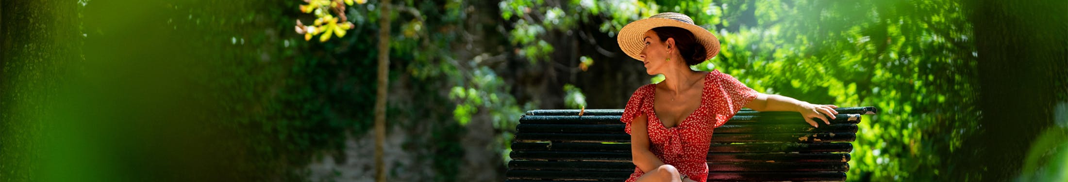 woman in hat on a bench