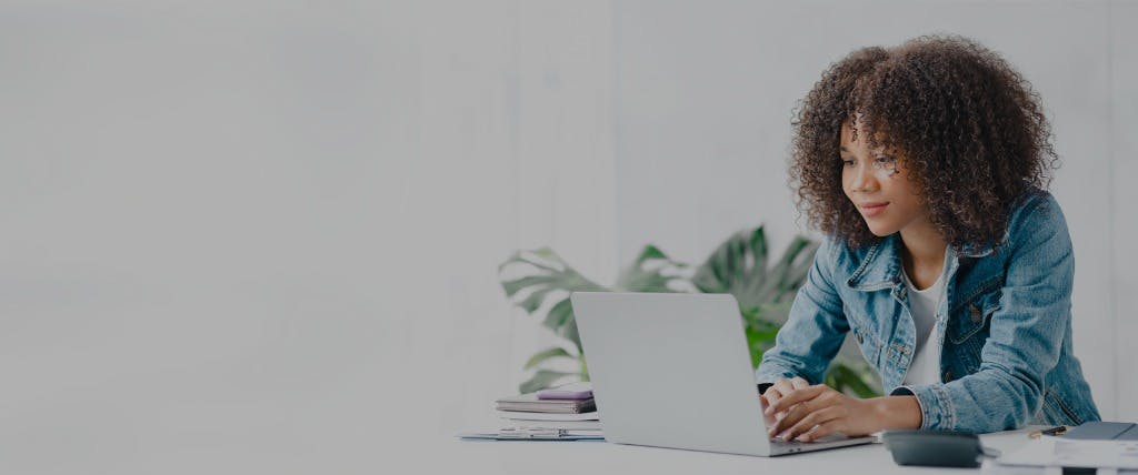 young woman reading on laptop
