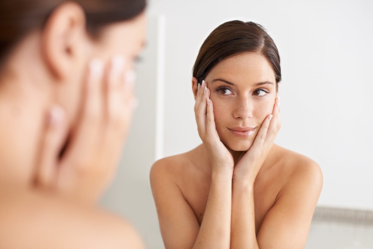 Woman touching her face