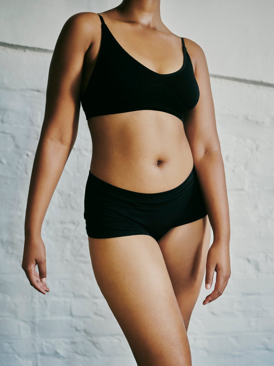 Woman in black underwear standing