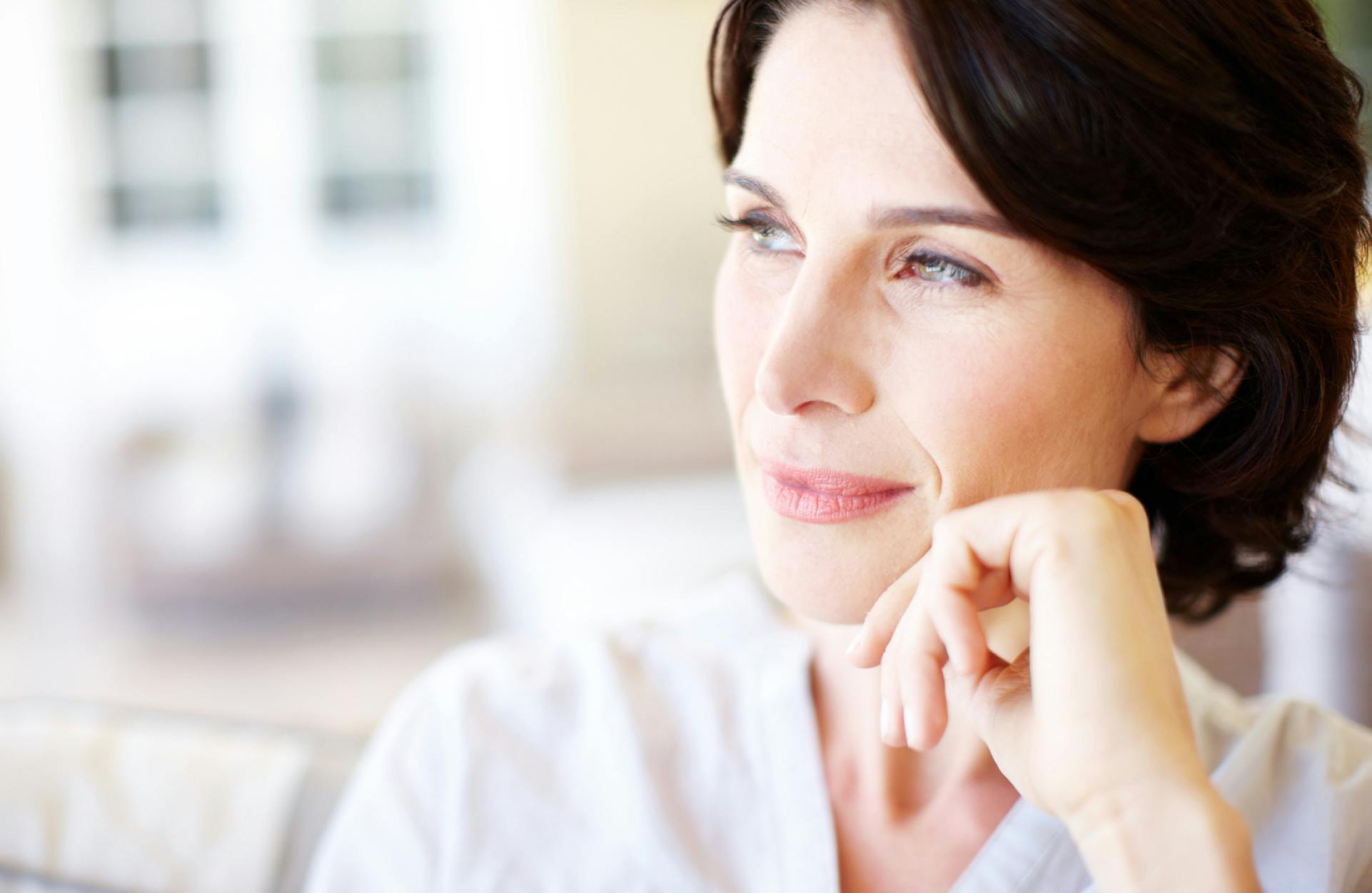 woman with short dark hair looking off into the distance