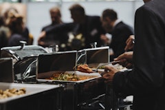 Person helps himself at the buffet lunch at a congress in the KKL Lucerne